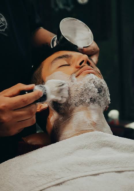 Client receiving a hot towel shave
